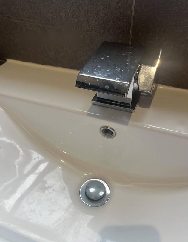 Limescale-marked chrome tap before cleaning